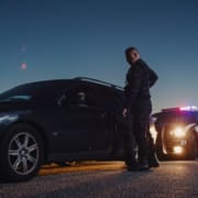 Portrait of Middle Aged Caucasian Cop Approaching a Pulled Over